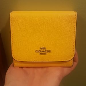 COACH small trifold snap wallet.